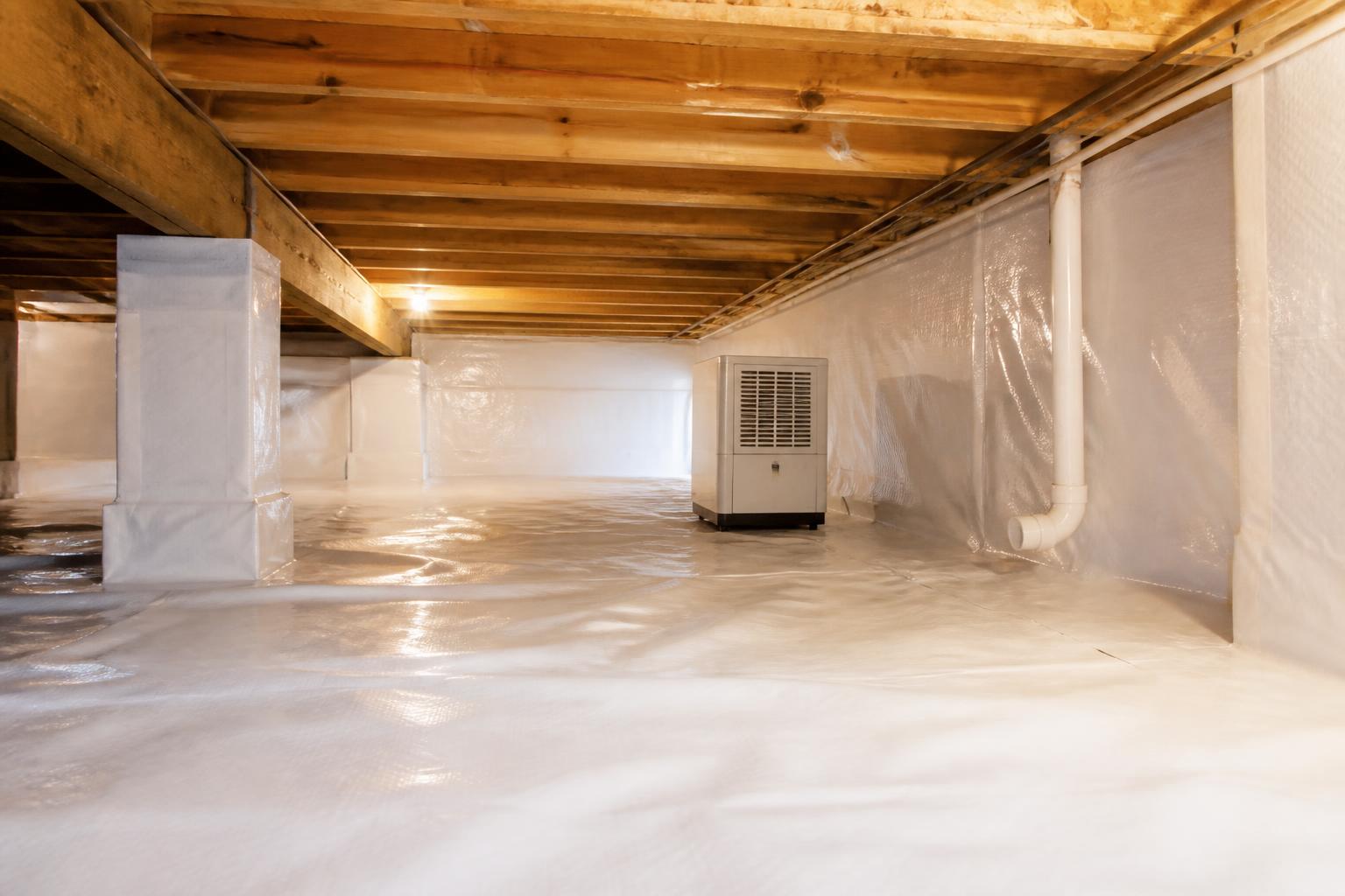 Encapsulated crawl space with a white vapor barrier and dehumidifier beneath a Franklin, Tennessee home